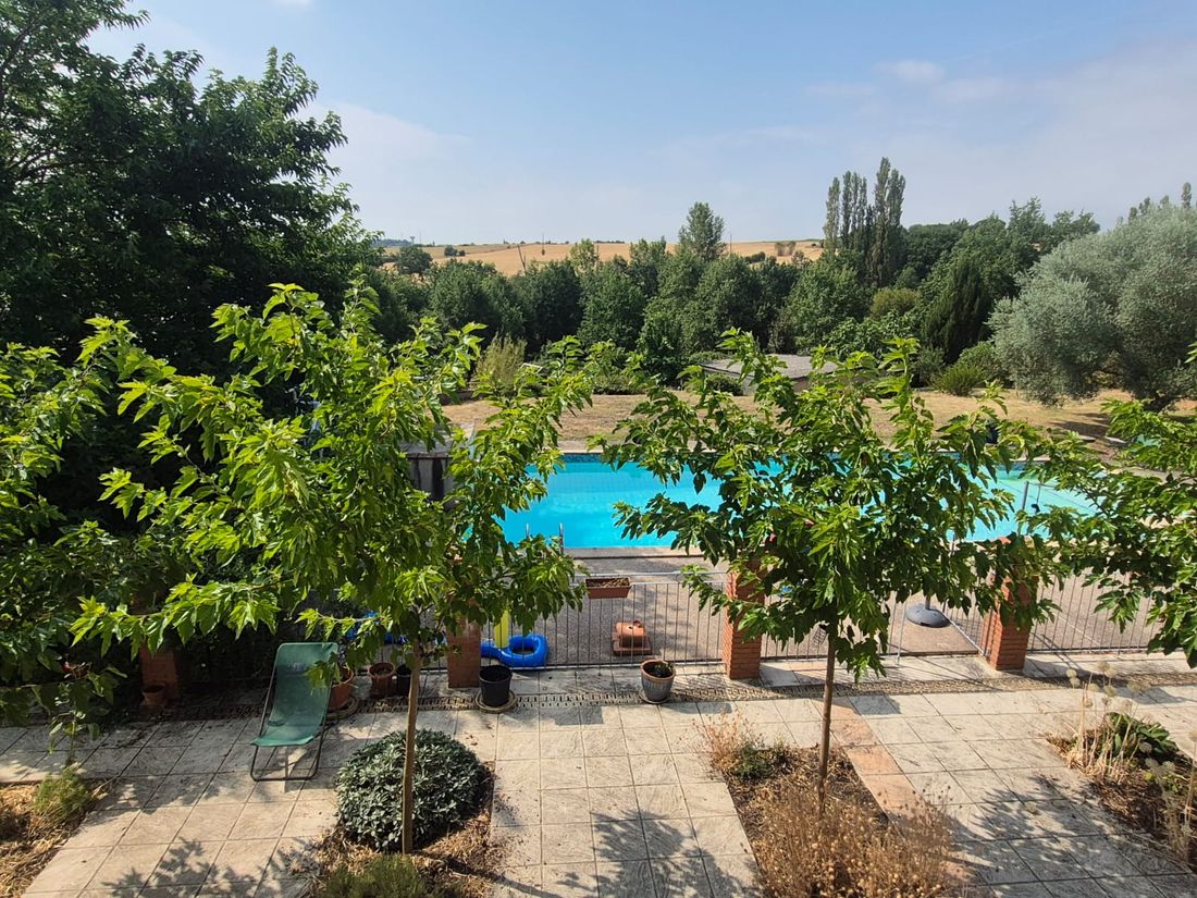 View over the pool and garden out to the Haute-Garonne countryside