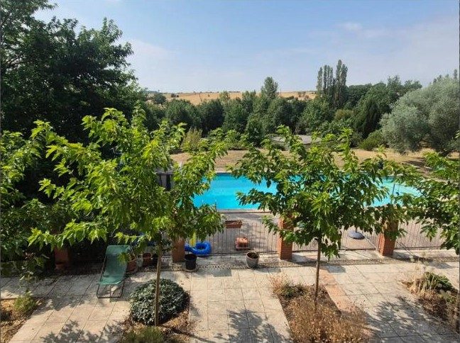 The family pool and garden, with the house in the background